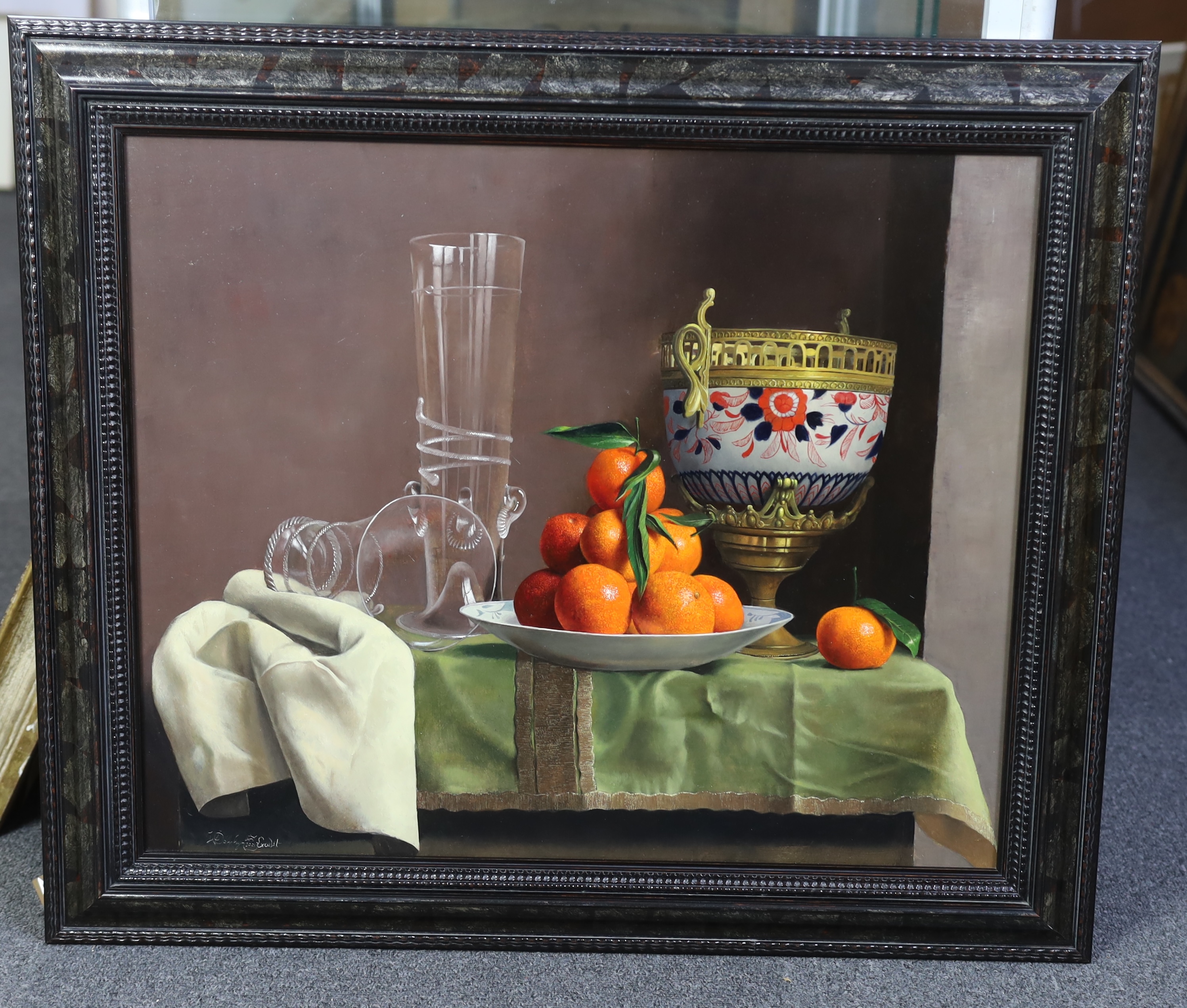Willem Dolphyn (Belgian, 1935-2016), Still life of oranges, glassware and an ormolu mounted vase upon a draped table, oil on panel, 49 x 58cm